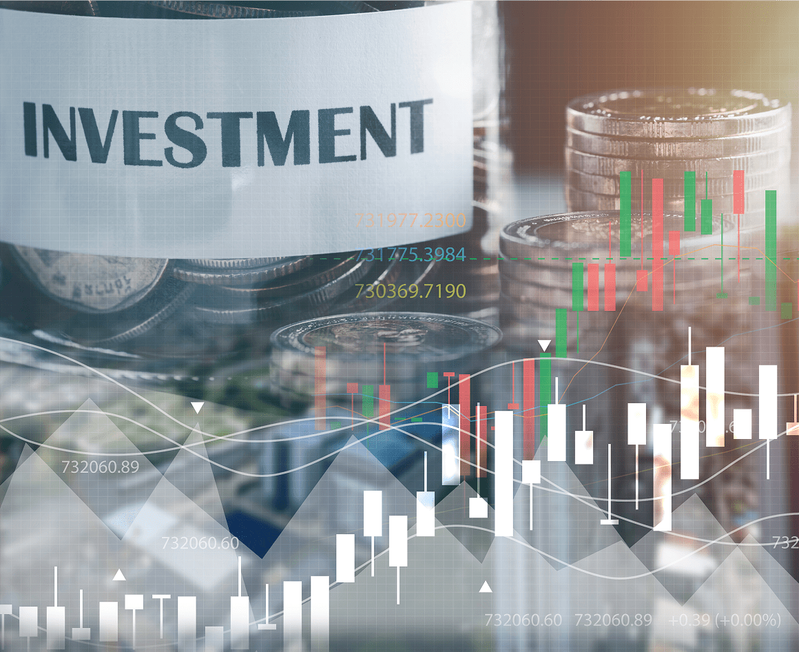 Investment concept with coins and financial graphs.