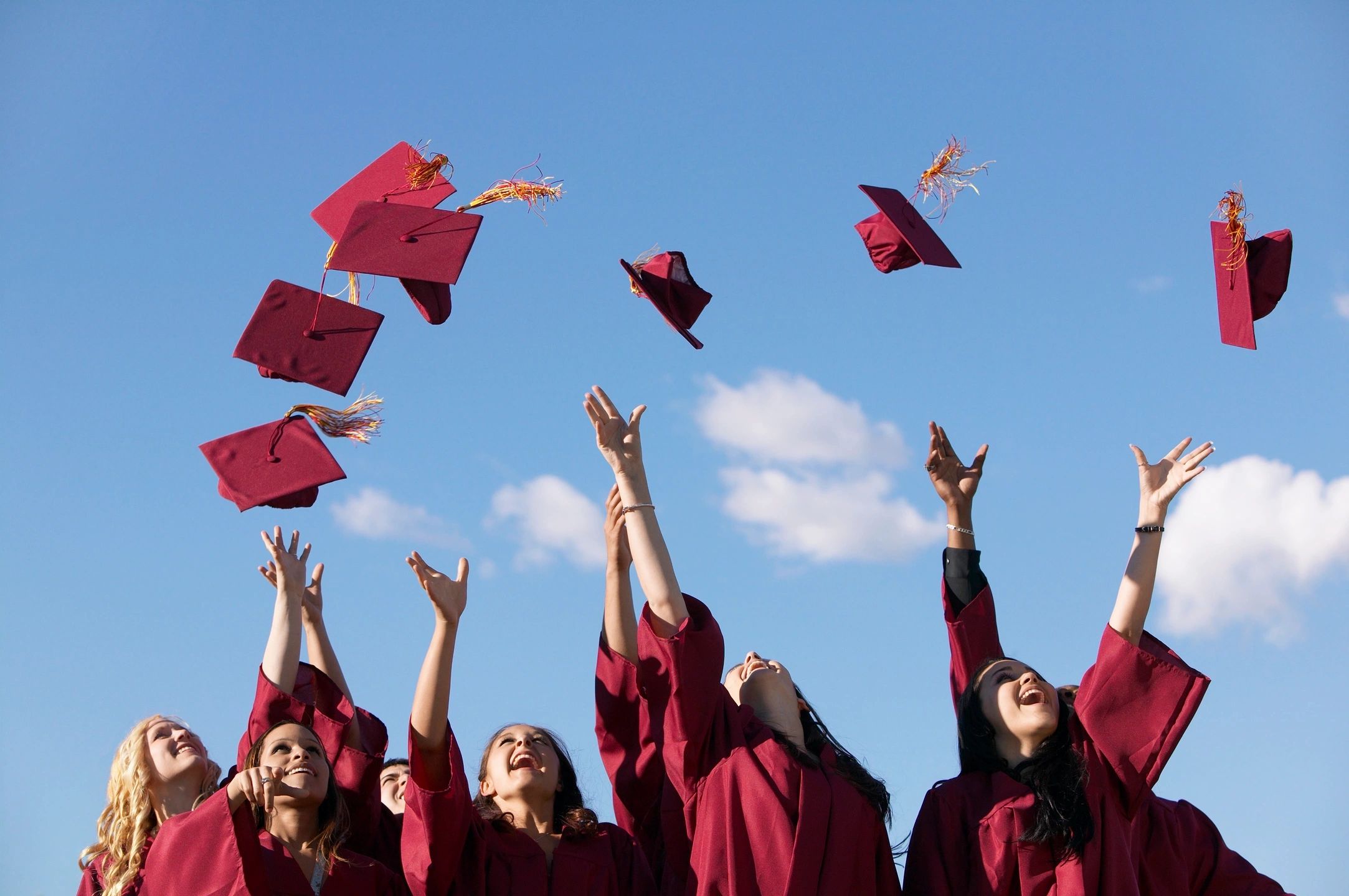 Students tossing graduation caps joyfully